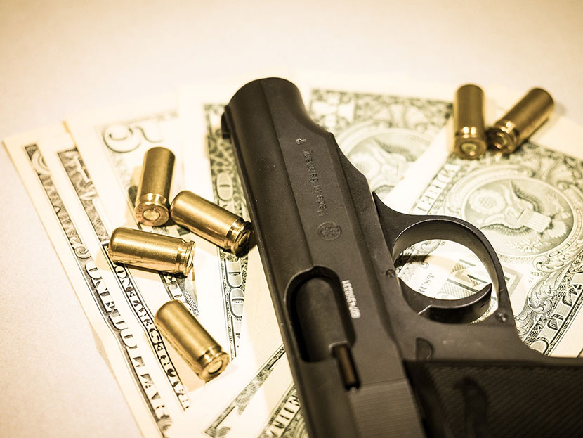Gun with bullet and money