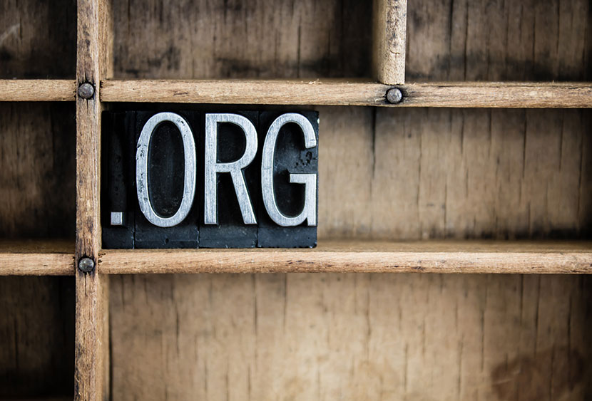 The abbreviation "DOT ORG" written in vintage metal letterpress type in a wooden drawer with dividers.