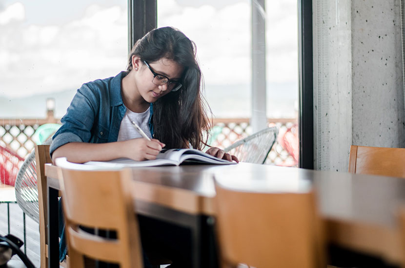 student writing on the book