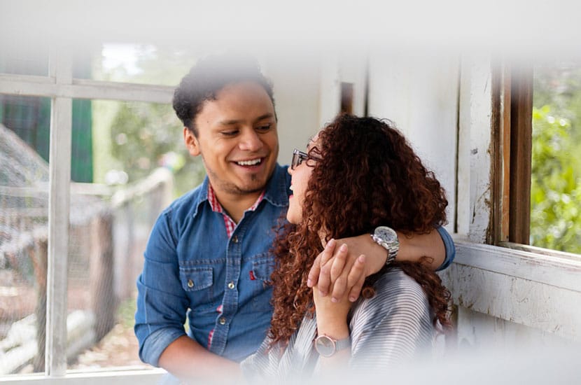 couple laughing and having fun in a cabin