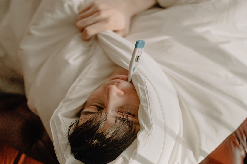 Man on t-shirt lying on bed