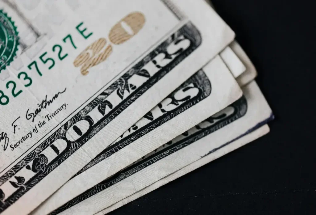 US dollar representing costs adjustment of status