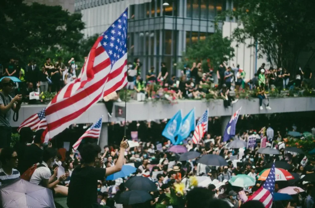Crowd waving American flags during a public event