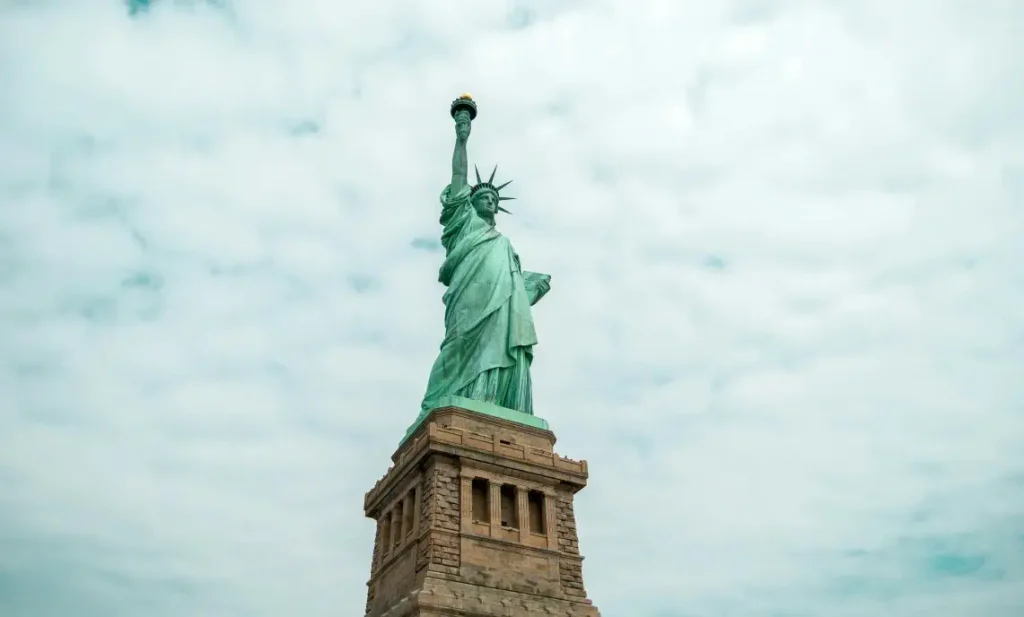 Statue of Liberty standing tall against a cloudy sky