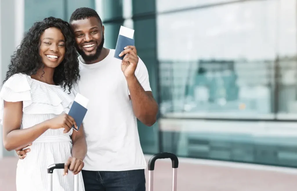 Smiling couple holding passports at the airport